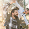 father playing with son in outdoors image