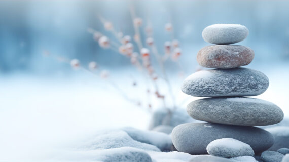 stack of pebbles or stones on winter outdoor background. Winter yoga